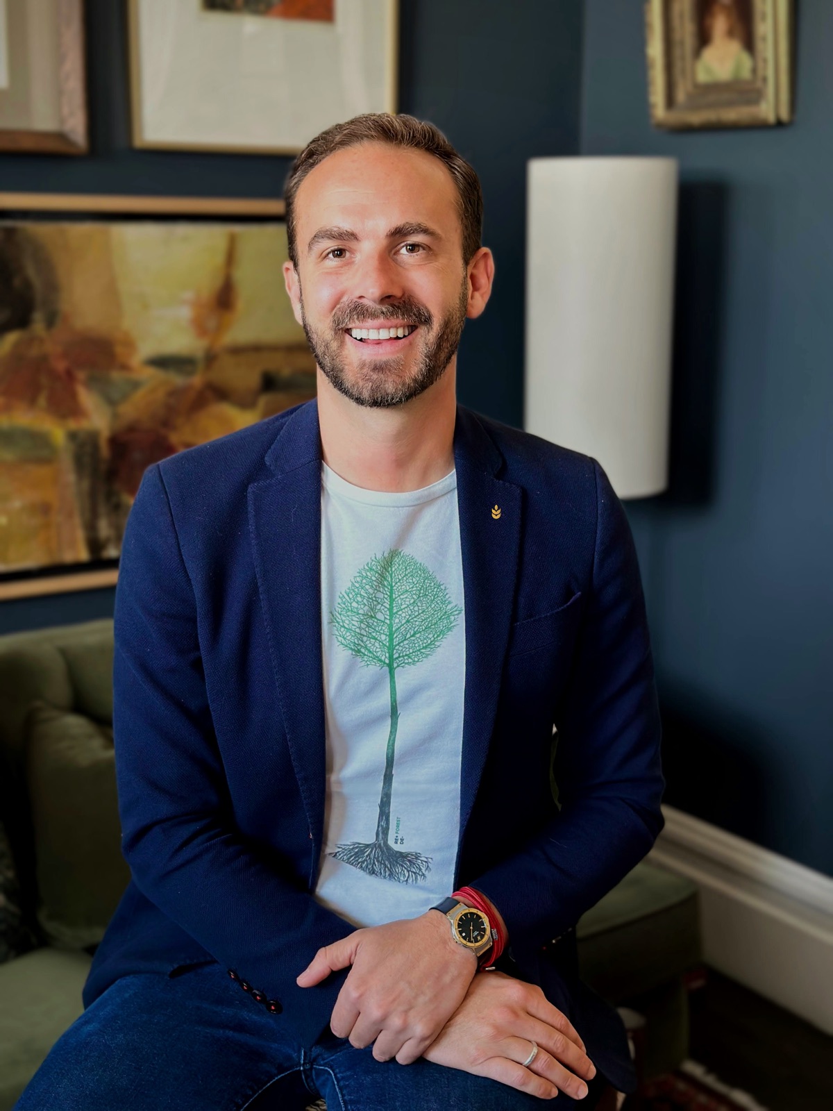 Alvaro smiling, in a navy blazer